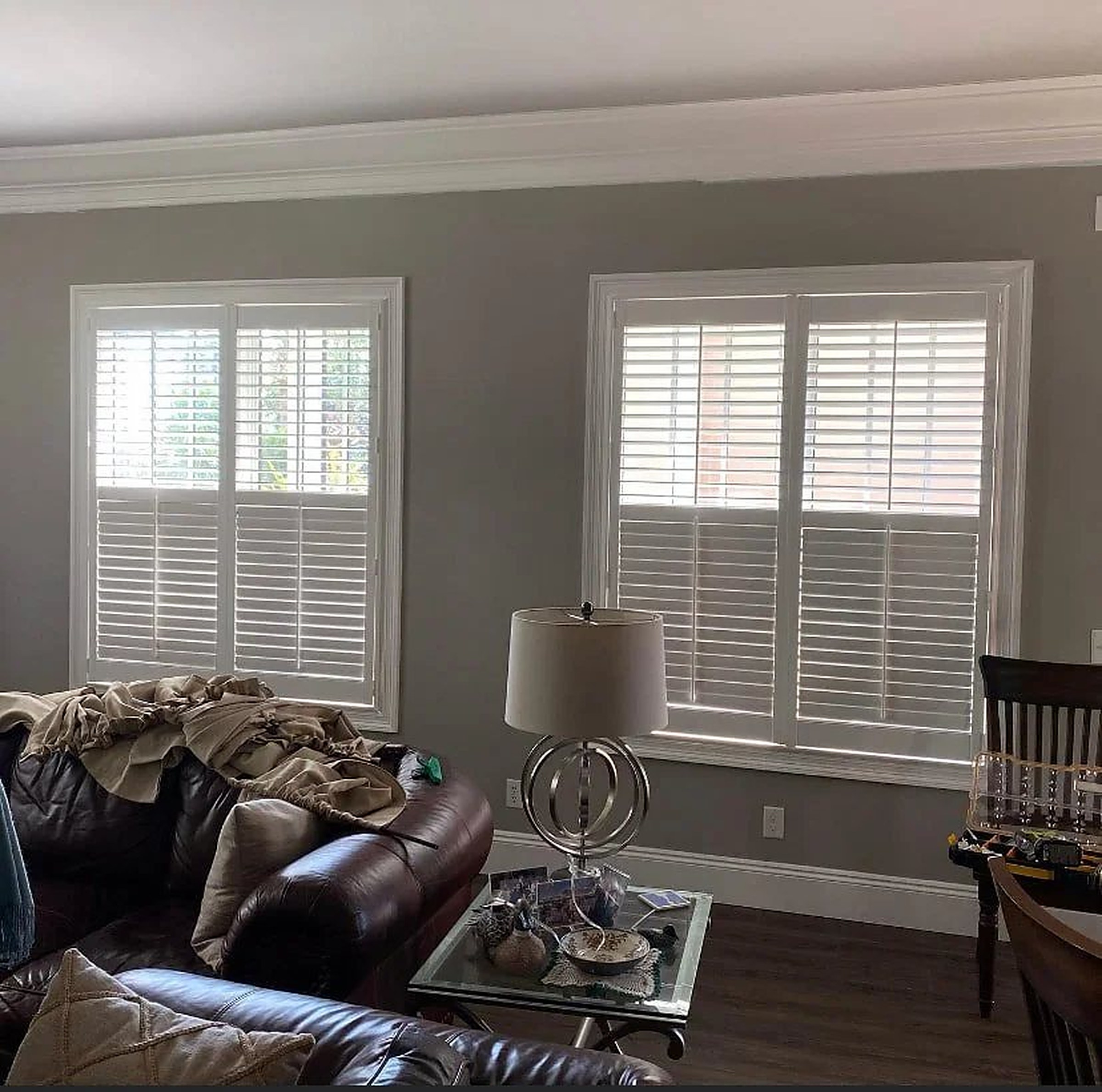 Sunlight filtering through white plantation shutter louvers
