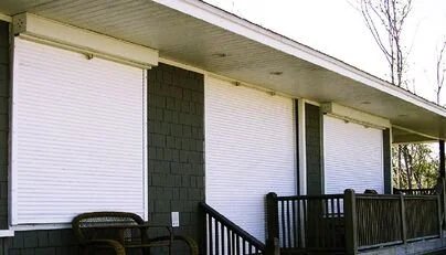 Rolling hurricane shutters along a home exterior